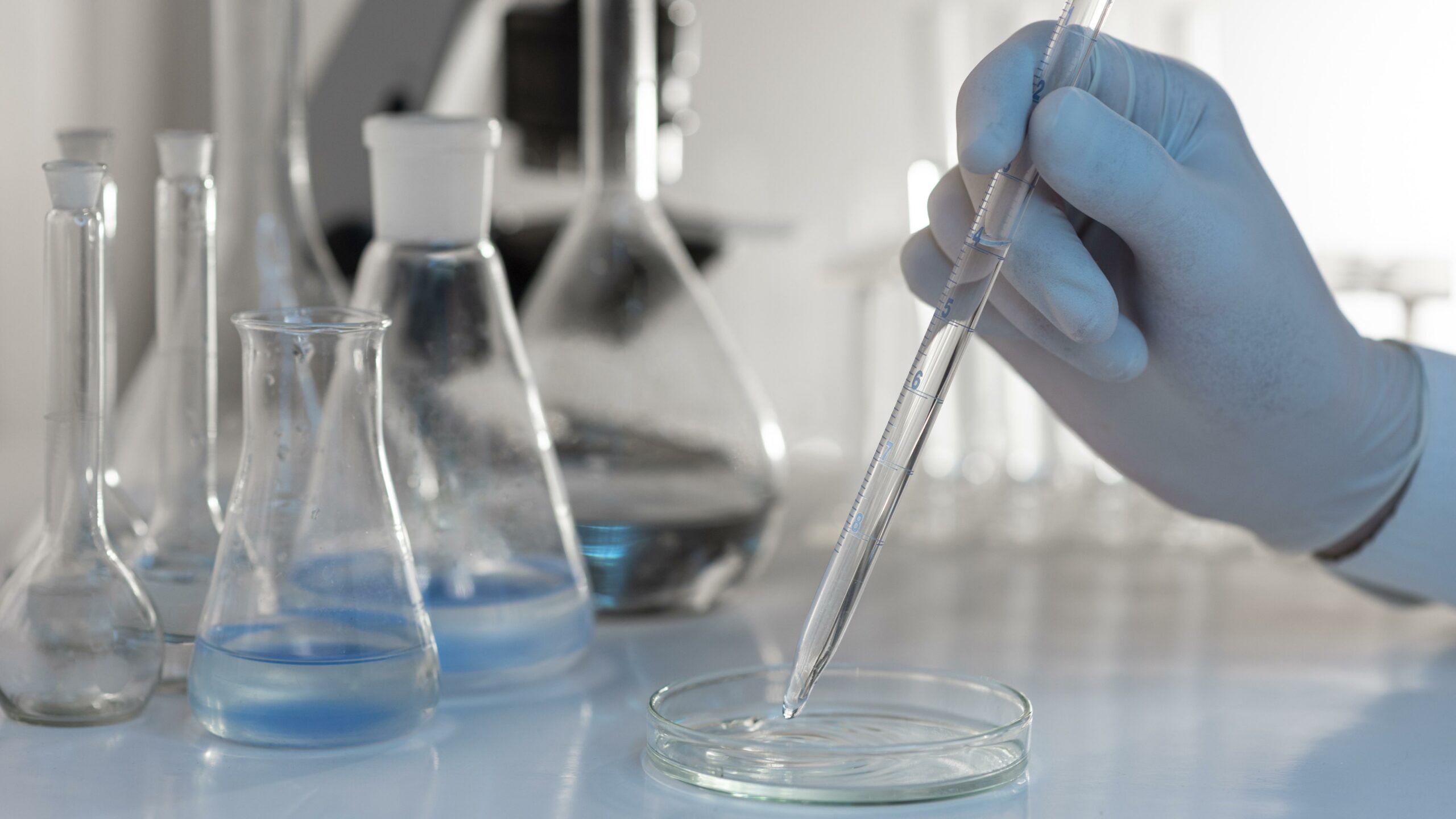 close-up-hand-holding-lab-pipette